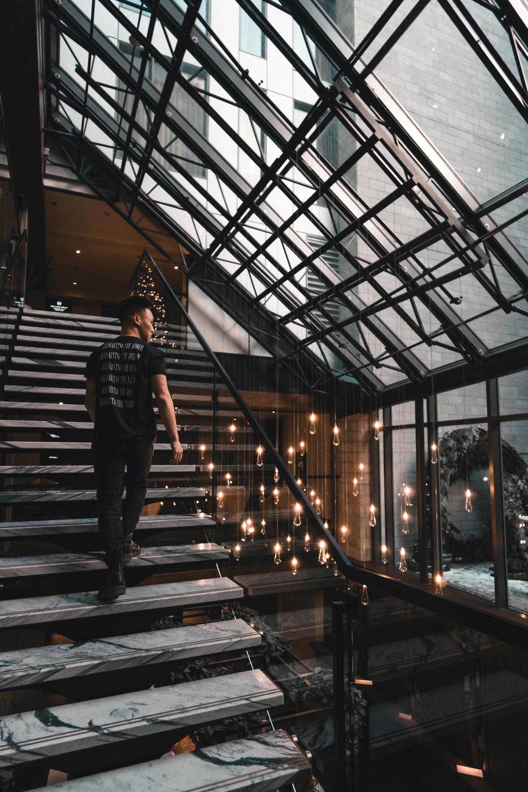 A man ascends a staircase in a stylish, modern hotel in Montréal, Canada.